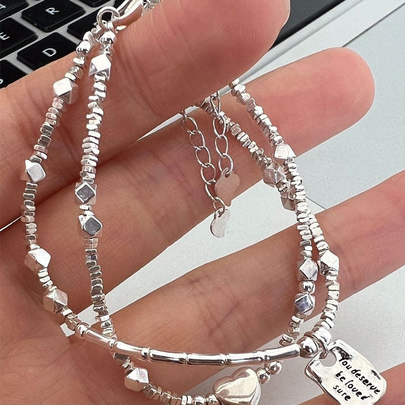 A few pairs of irregularly broken silver bracelets with heart-shaped square brand bamboo joints