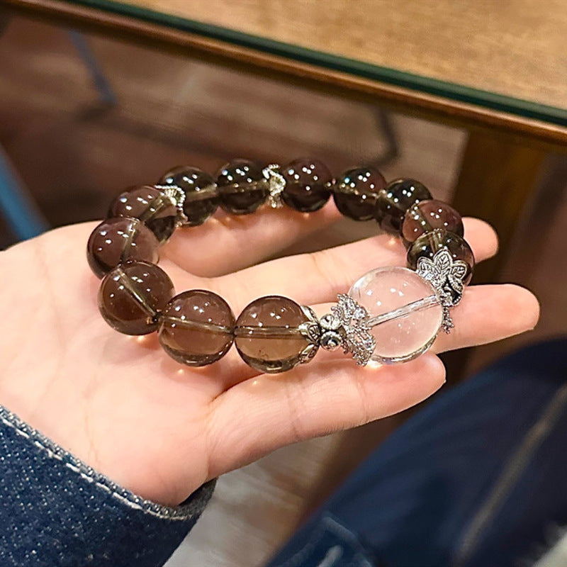 A 12mm single-ring bracelet made of natural tea crystal paired with white crystal