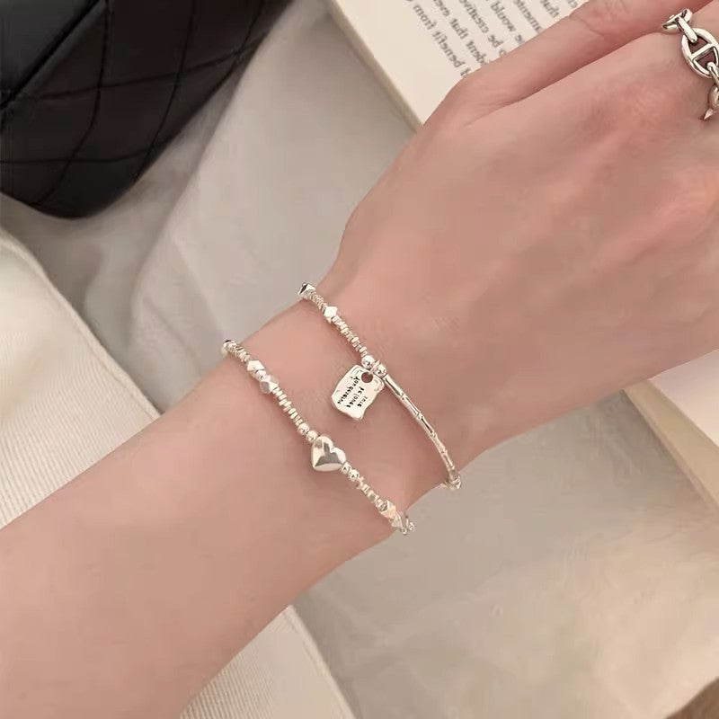 A few pairs of irregularly broken silver bracelets with heart-shaped square brand bamboo joints