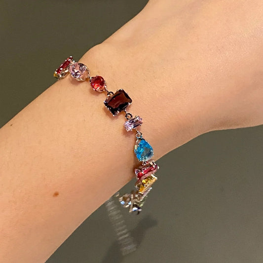A rainbow-colored crystal candy with a dazzling and colorful bracelet