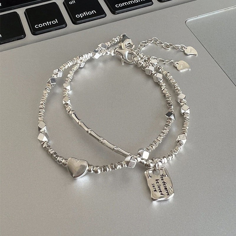 A few pairs of irregularly broken silver bracelets with heart-shaped square brand bamboo joints