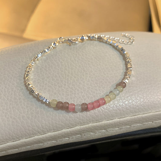 A string of beads is made by stacking small pieces of silver