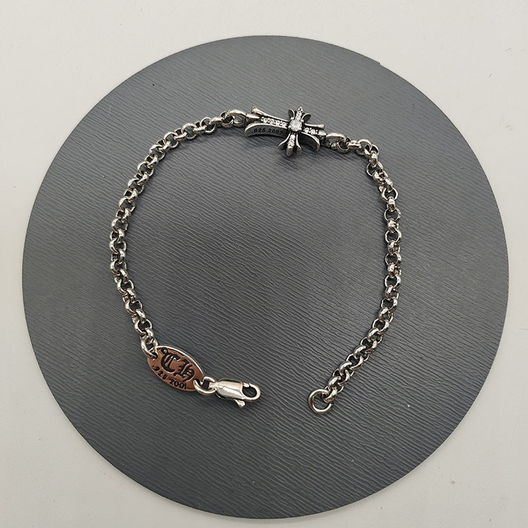 The S925 bracelet features a sword, anchor and cross flower