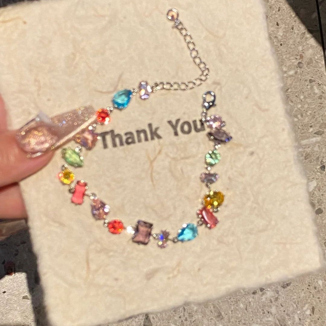 A rainbow-colored crystal candy with a dazzling and colorful bracelet