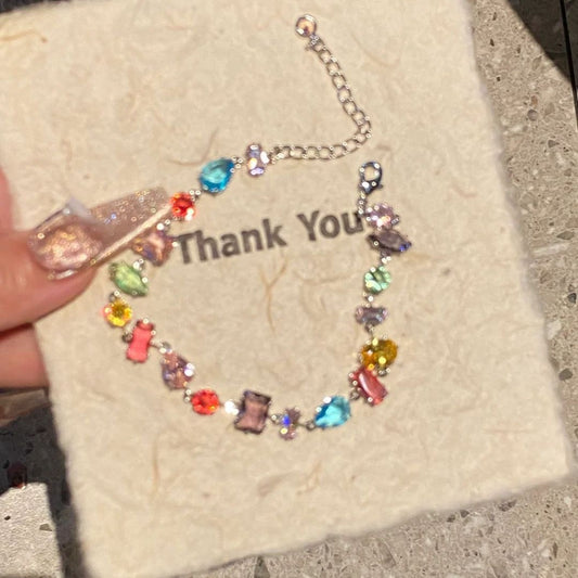 A rainbow-colored crystal candy with a dazzling and colorful bracelet