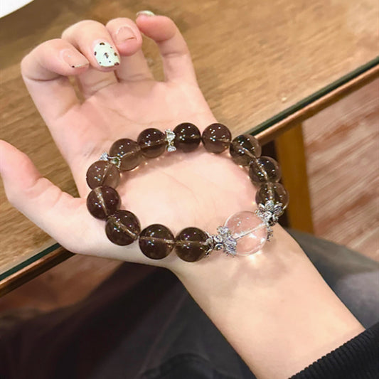 A 12mm single-ring bracelet made of natural tea crystal paired with white crystal