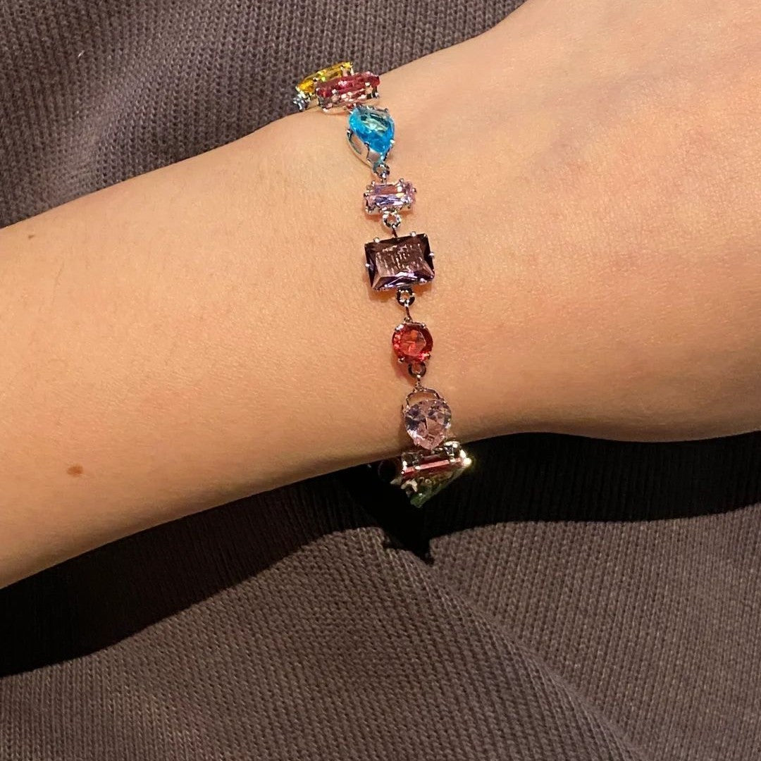 A rainbow-colored crystal candy with a dazzling and colorful bracelet