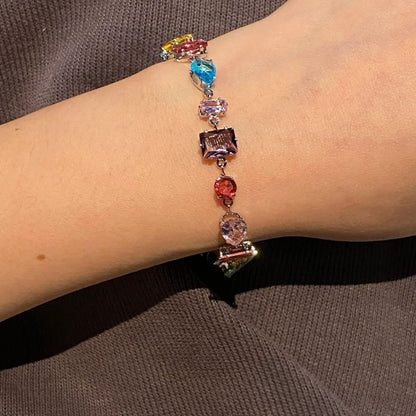A rainbow-colored crystal candy with a dazzling and colorful bracelet