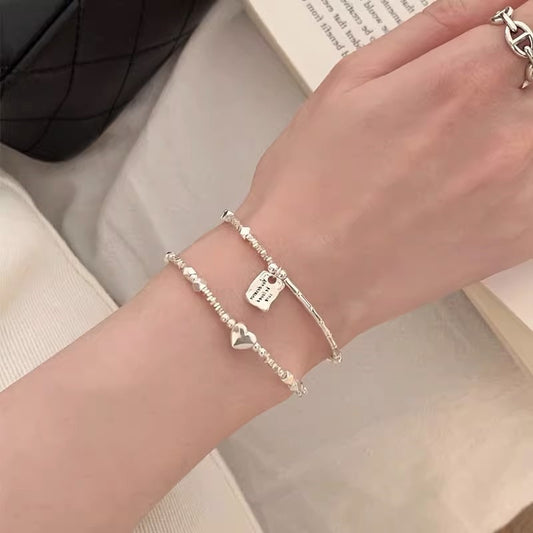 A few pairs of irregularly broken silver bracelets with heart-shaped square brand bamboo joints